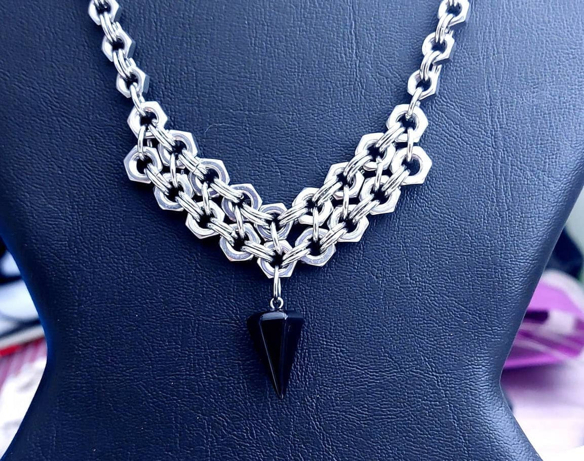 Nutz n Chains silver chain necklace statement with black pendant on black display