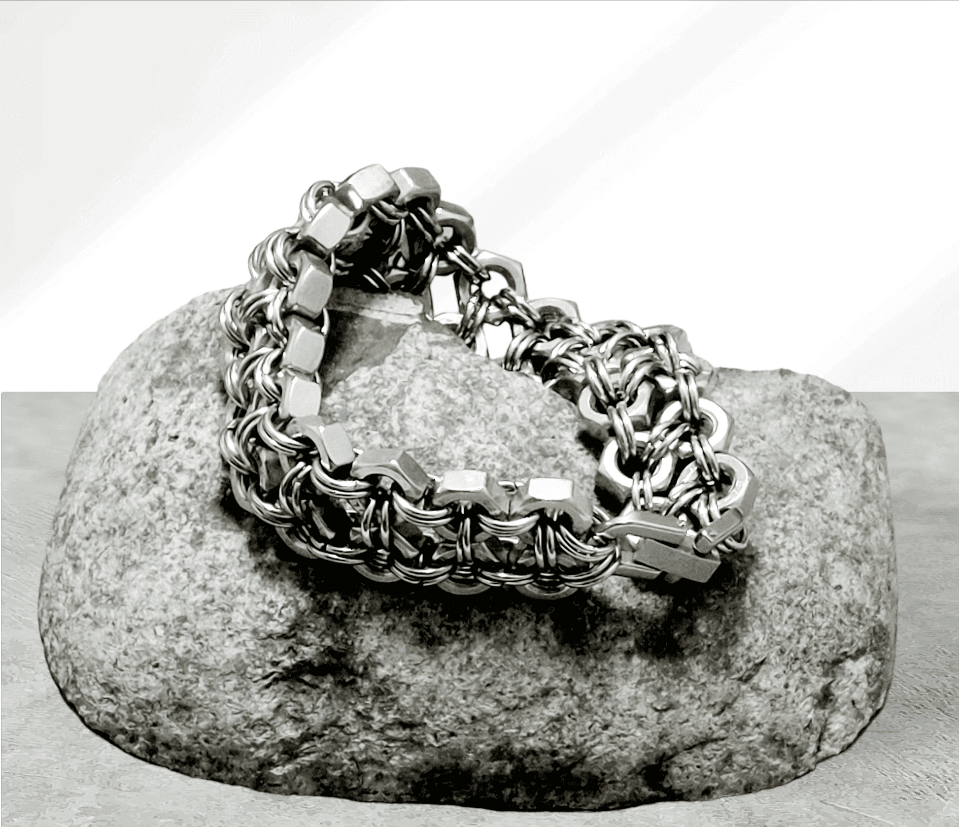 Silver chain cuff cuff bracelet with hexagonal links displayed on a gray stone by Nutz n Chains