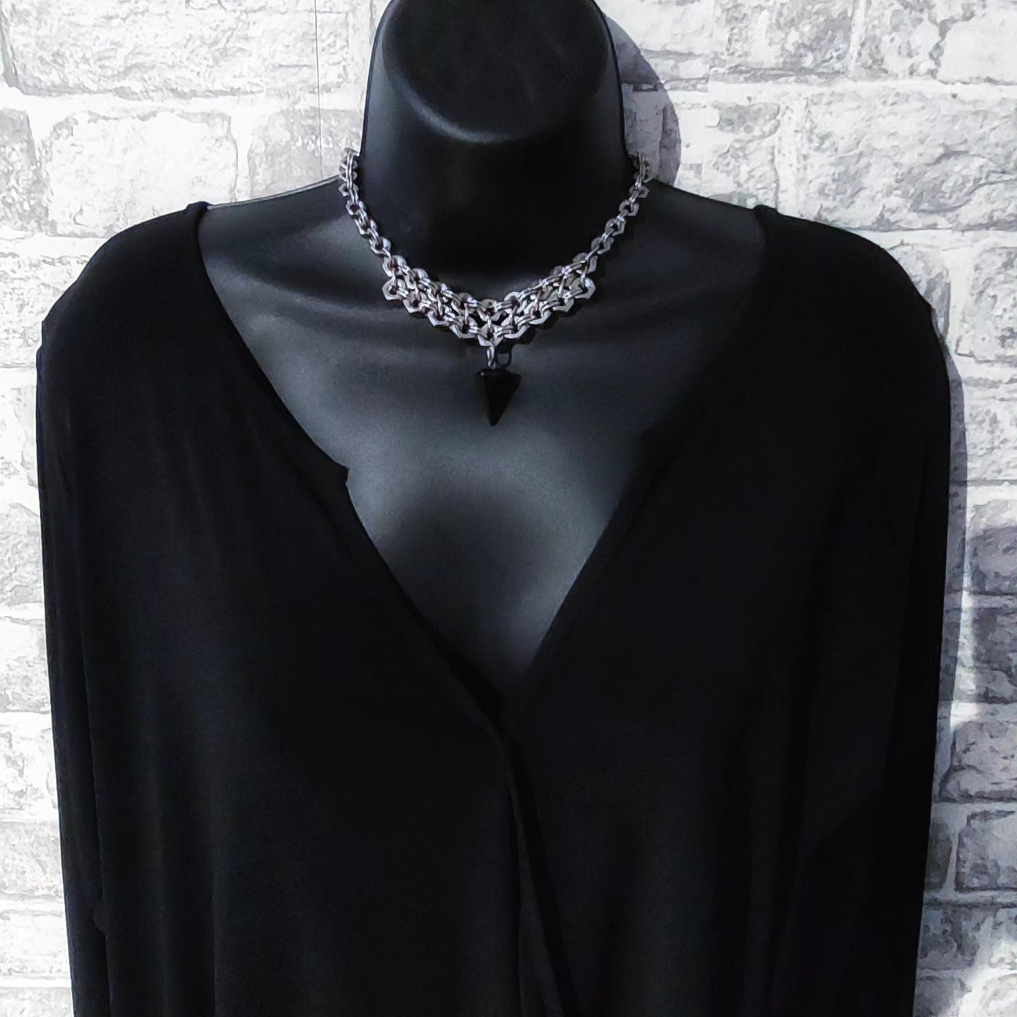 Nutz n Chains silver chain necklace statement with black arrowhead pendant on black mannequin