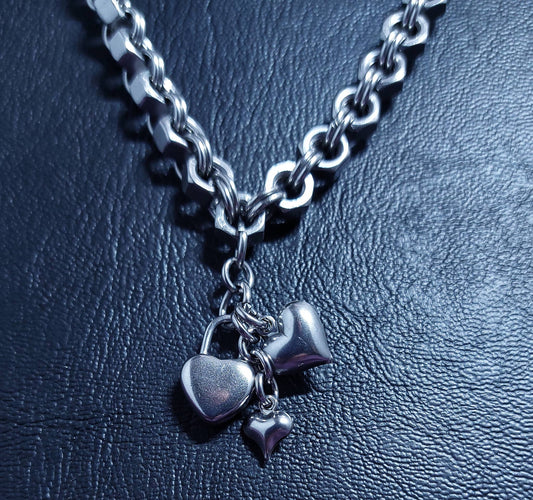 Silver heart-shaped charms for charm necklace hanging on chunky silver chain necklace by Nutz n Chains