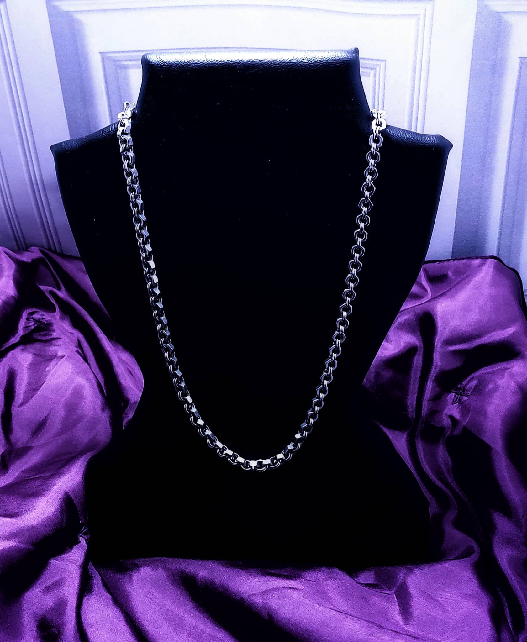 Silver chain necklace displayed on black bust with purple satin background by Nutz n Chains
